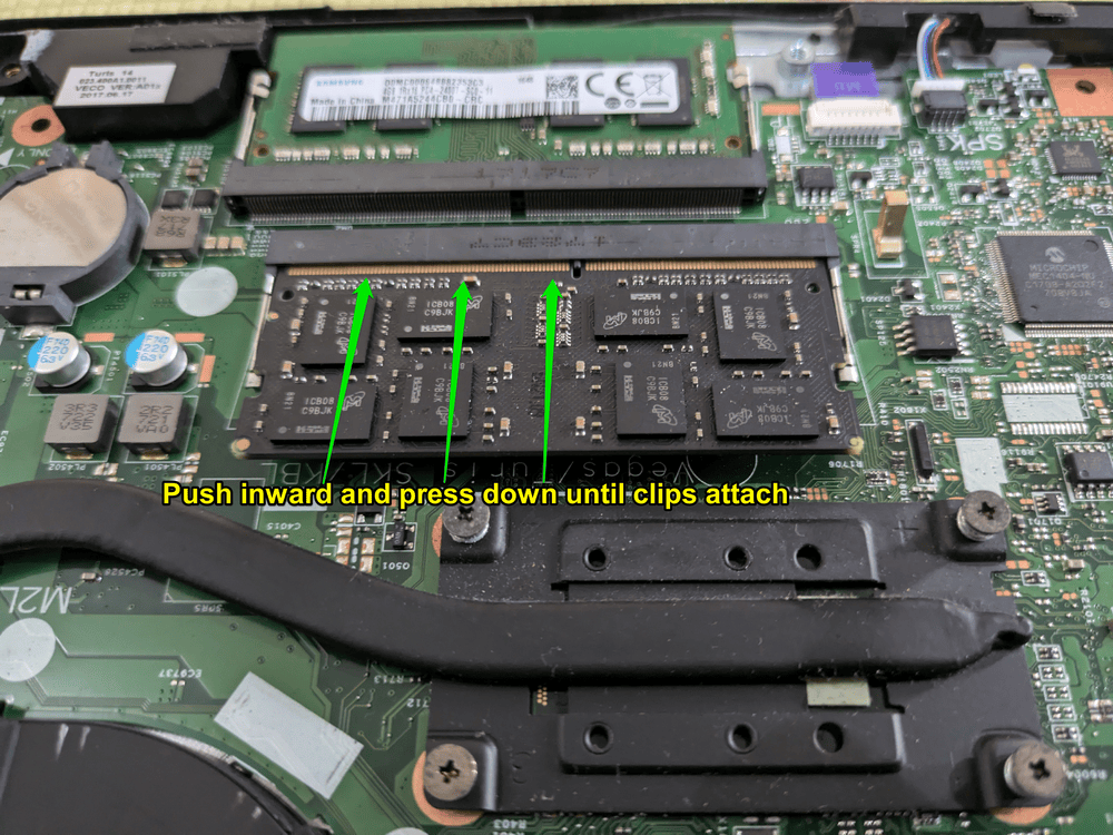 Ensure the RAM’s gold pins are completely inside the slot or no longer visible before pressing down